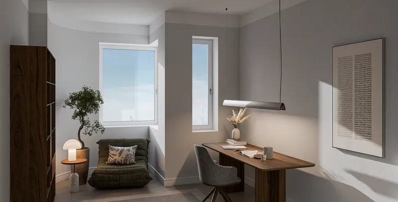 Flexibel nutzbares Zimmer mit Schreibtisch am Fenster und Leseecke.