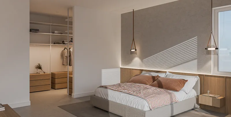 Schlafbereich des Penthouses mit angrenzender offener Ankleide.